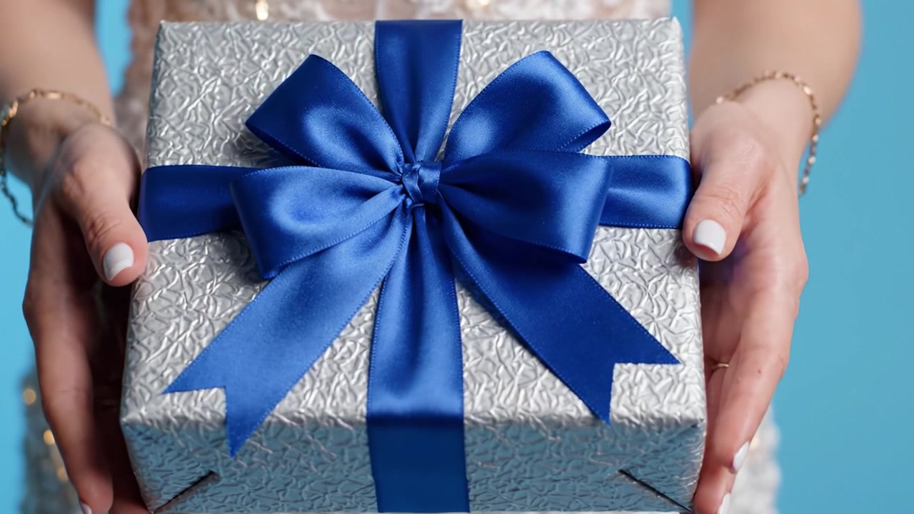 A Celebratory Moment Captured: A Close-Up of Elegant Gift Packaging with a Beautiful Blue Bow, Perfect for Special Occasions and Everlasting Memories