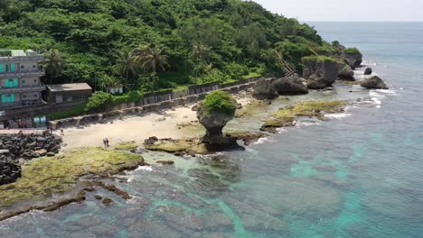 Cinematic-aerial-drone-hovering-around-popular-landmark-coral-reef-flower-vase-rock-at-Xiaoliuqiu,-Lambai-island,-Pingtung-county,-Taiwan