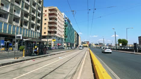 tram travels through urban naples, italy