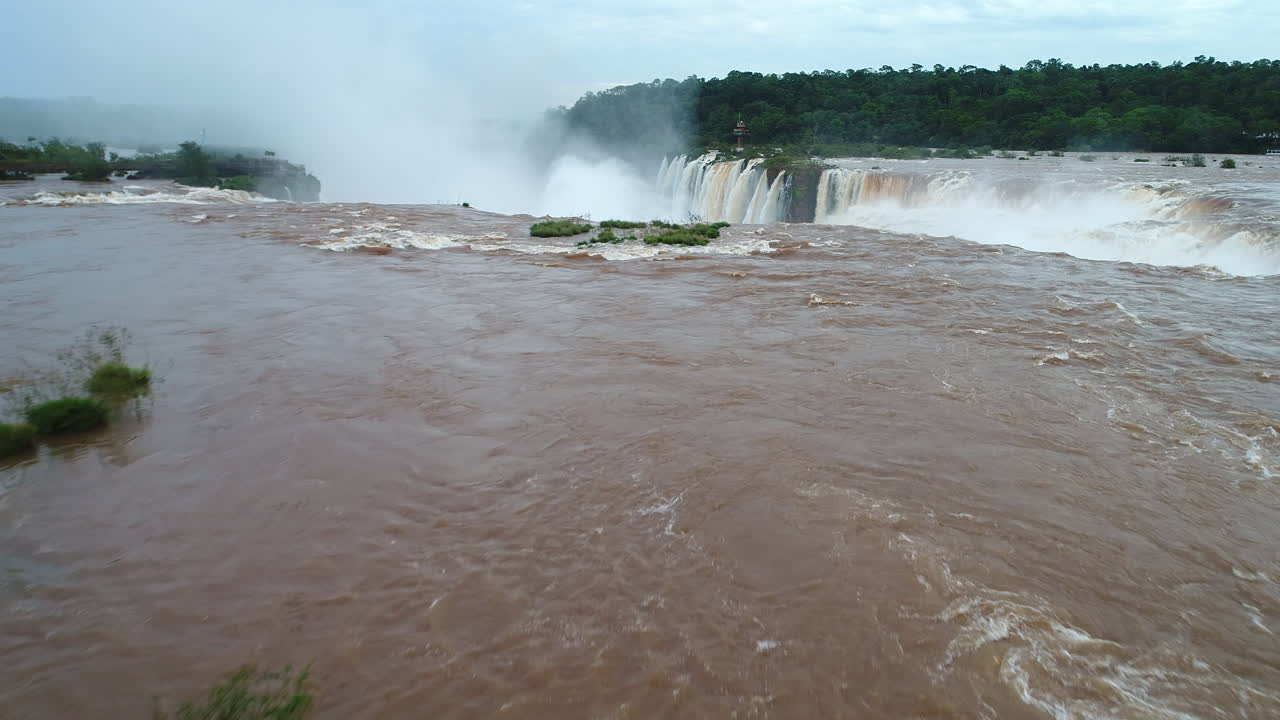 Drone's low-flight over the river, revealing the immense Devil's Throat in Iguazu Falls