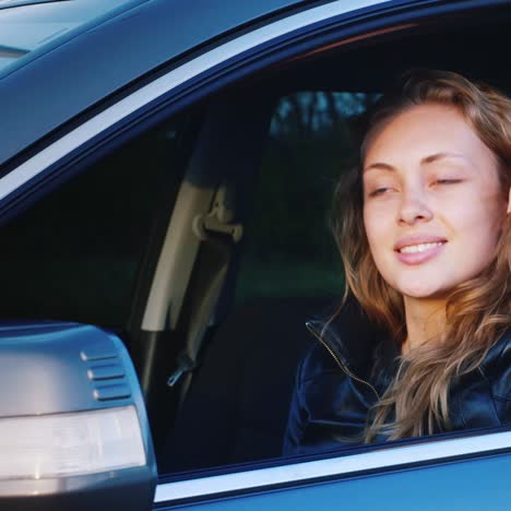 Portrait-Of-A-Young-Caucasian-Woman-In-A-Car