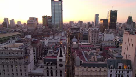 Aerial-shot-of-an-epic-sunset-of-the-city-of-Buenos-Aires,-old-and-new-architecture-of-the-downtown-area