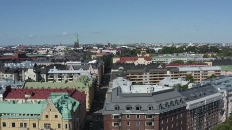 Sideways-aerial-dolly-of-Helsinki-Finland-color-buildings-church-tower