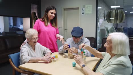 elderly people playing with blocks with nurse assistance