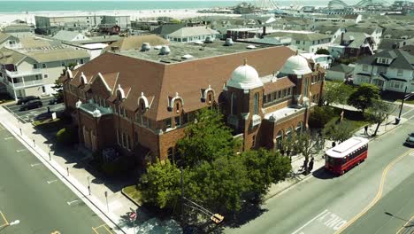 aerial tilt up to a catholic church near the beach in stone harbor, new jersey