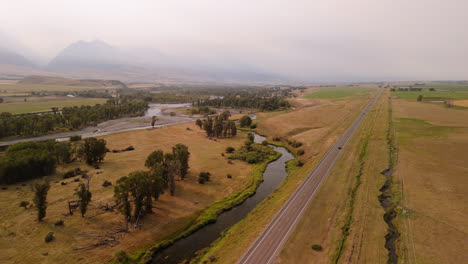 aerial view of a rural valley with river and road
