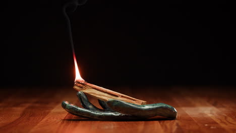 burning palo santo incense in ceramic hand