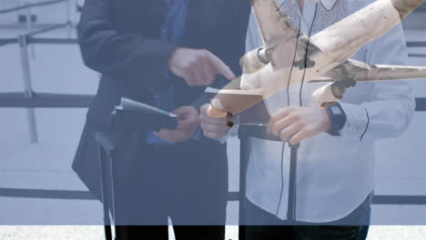 airplane flying against couple checking their passports in the airport