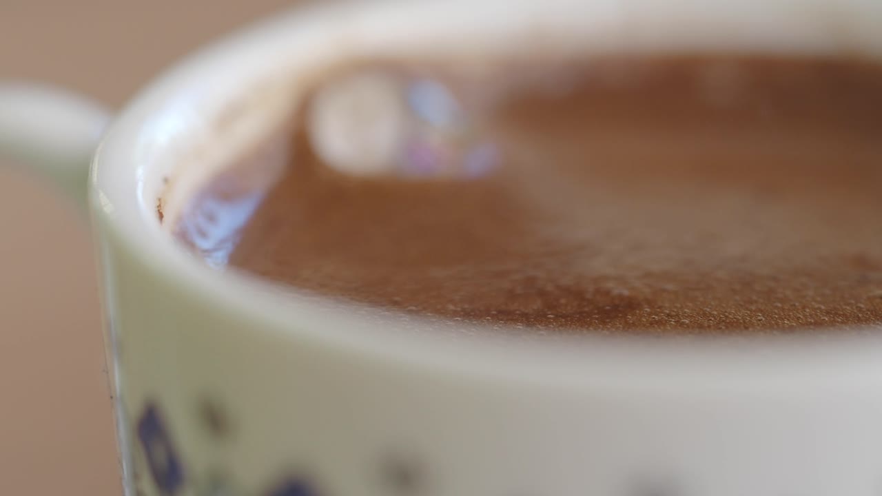 Close-up of a warm coffee or hot chocolate drink in a mug