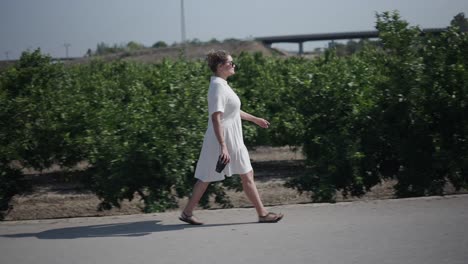 woman walking in an orange grove