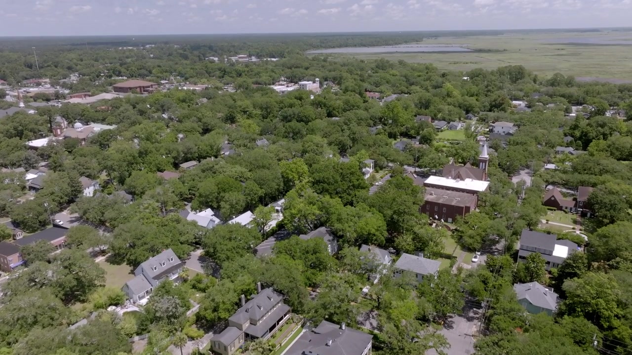 Neighborhood homes in Georgetown, South Carolina with drone video moving in.