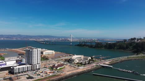 Wide-angle-drone-shot-of-Treasure-Island-construction-and-The-Bay-Bridge-midday