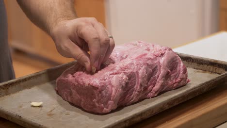 Timelapse-of-adding-garlic-to-Wagyu-Kobe-beef,-inserting-cloves-into-the-meat