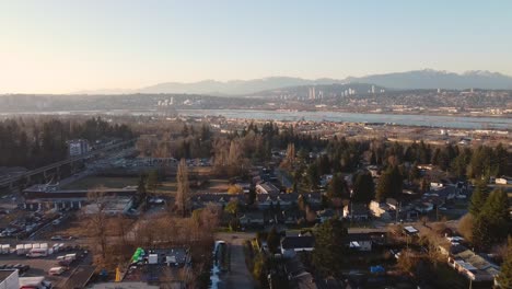 whalley surrey bc city neighbourhood aerial panning down to apartments condo buildings homes on a small road slowly reversing