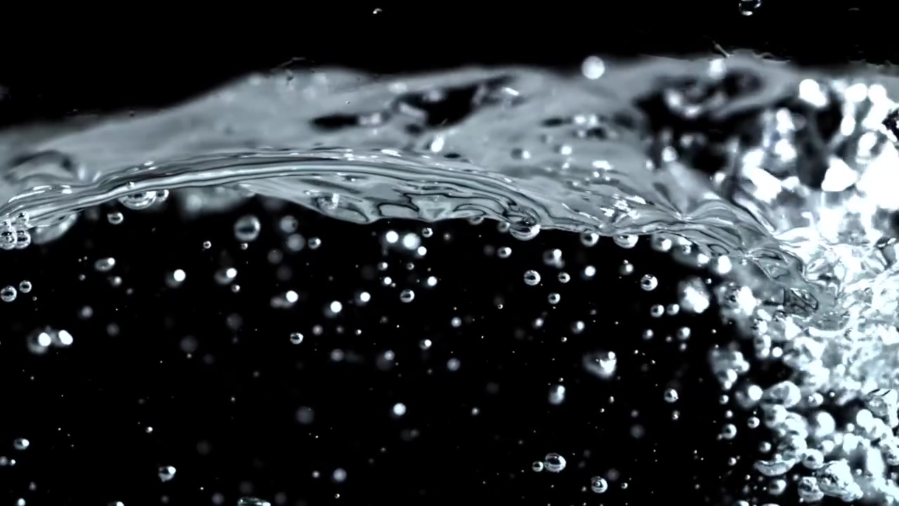 Close-up of Clear Water Splashing and Bubbling on Black Background