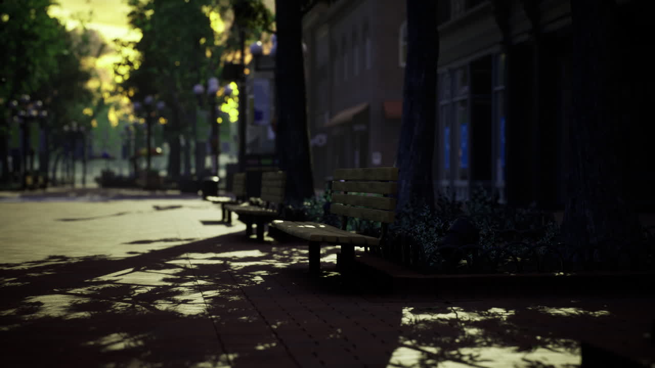 Empty park benches under golden sunset in town square with shadows