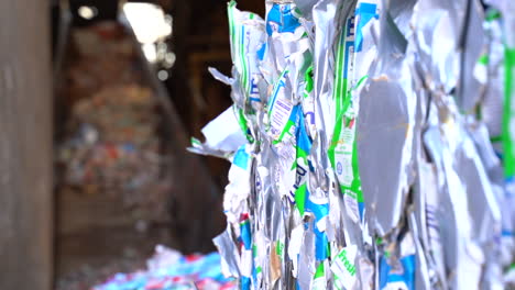 cinematic shot of bales of flattened milk cartons ready for recycling