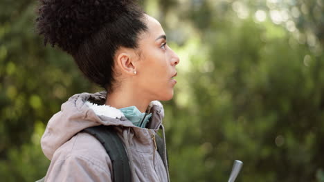 woman hiking, forest drinking water bottle