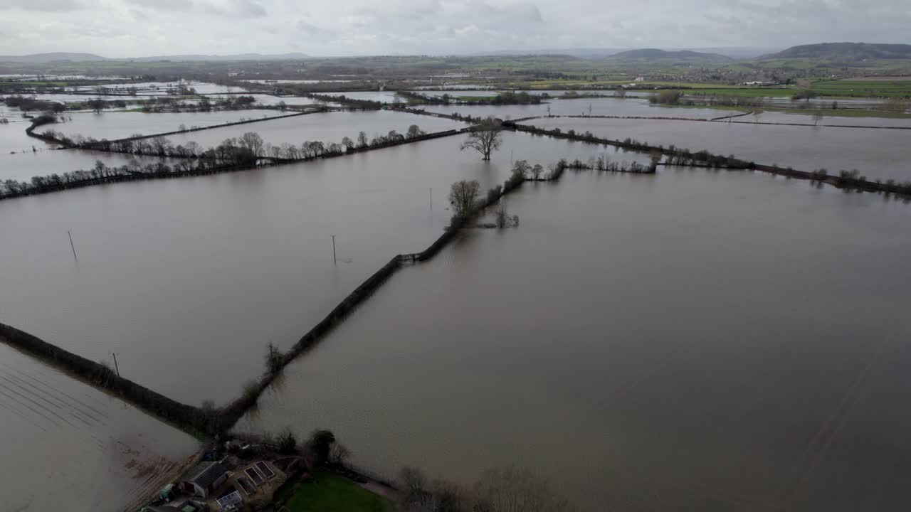 Flooded farm fields after storm in England aerial panning shot 4K