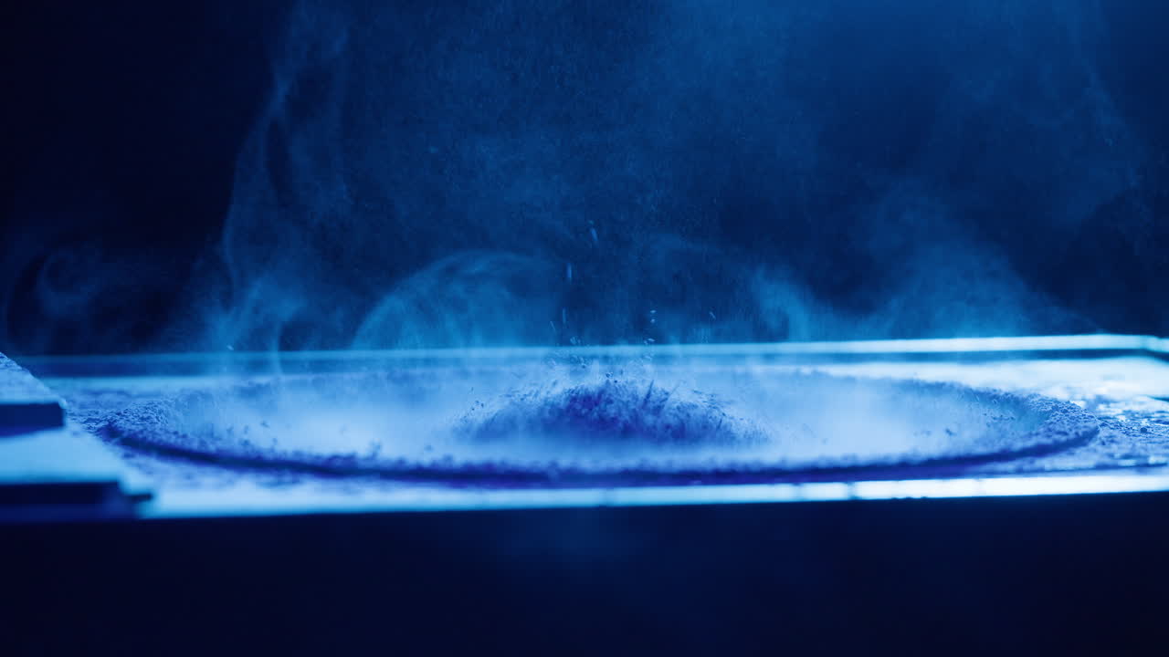 Close-up of Powder Vibrating on Speaker with Blue Light
