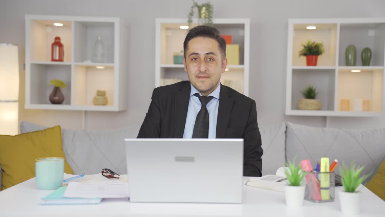 Home office worker man looking at camera with excitement and feeling happy.