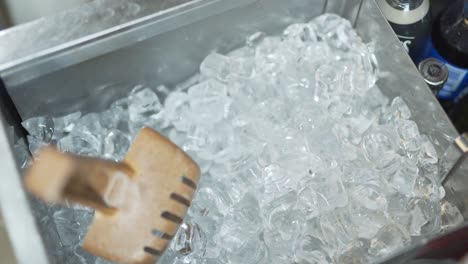 top view of ice cubes box with a big wooden spoon inside