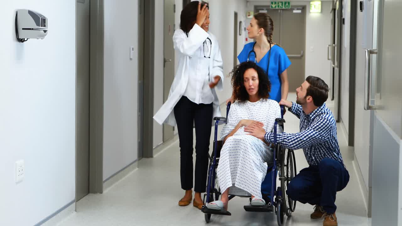 Doctors rushing pregnant woman to the emergency room