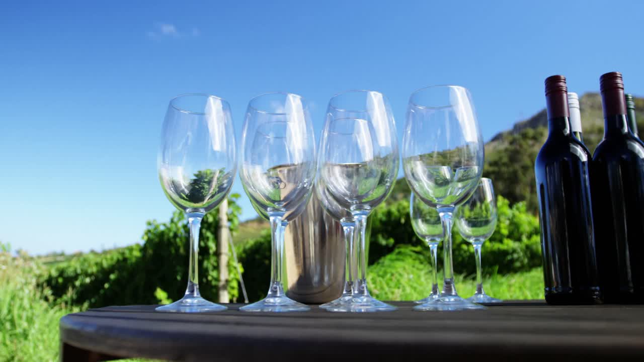 Close-up of wine glasses and bottles arranged on table