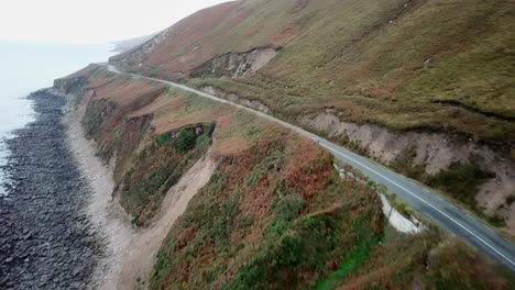 car driving in ireland next to the ocean, dingle peninsula