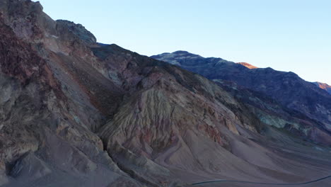 Beautiful,-orbital-drone-shot-of-artist's-drive-at-sunset