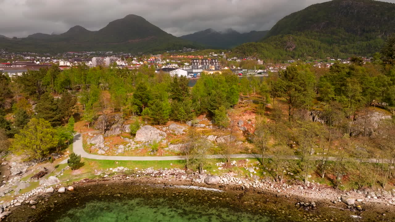 Aerial riser reveal shot of Jorpeland town from over Jorpelandsholmen island