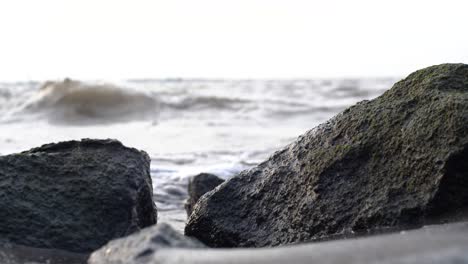 close up of rock crevice with ocean waves in the background