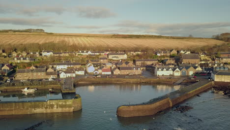 Aerial-footage-of-Johnshaven-harbour-and-town-at-sunrise,-Aberdeenshire,-Scotland