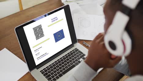 Woman-in-headphones-at-desk,-covid-vaccination-certificate-with-qr-code-and-eu-flag-on-laptop-screen