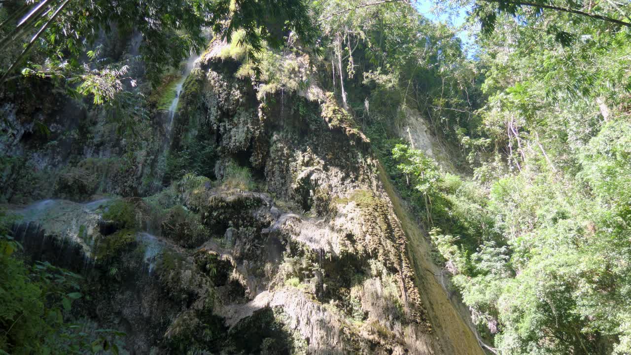 Tumalog Falls water cascading down a mossy cliff in Cebu, Philippines