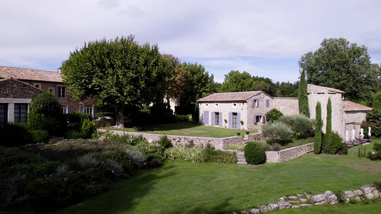 Aerial establishing shot of rural mansions in the Goult countryside, france