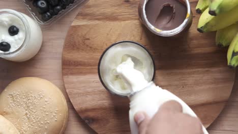 healthy breakfast with yogurt, milk, bananas, and bread