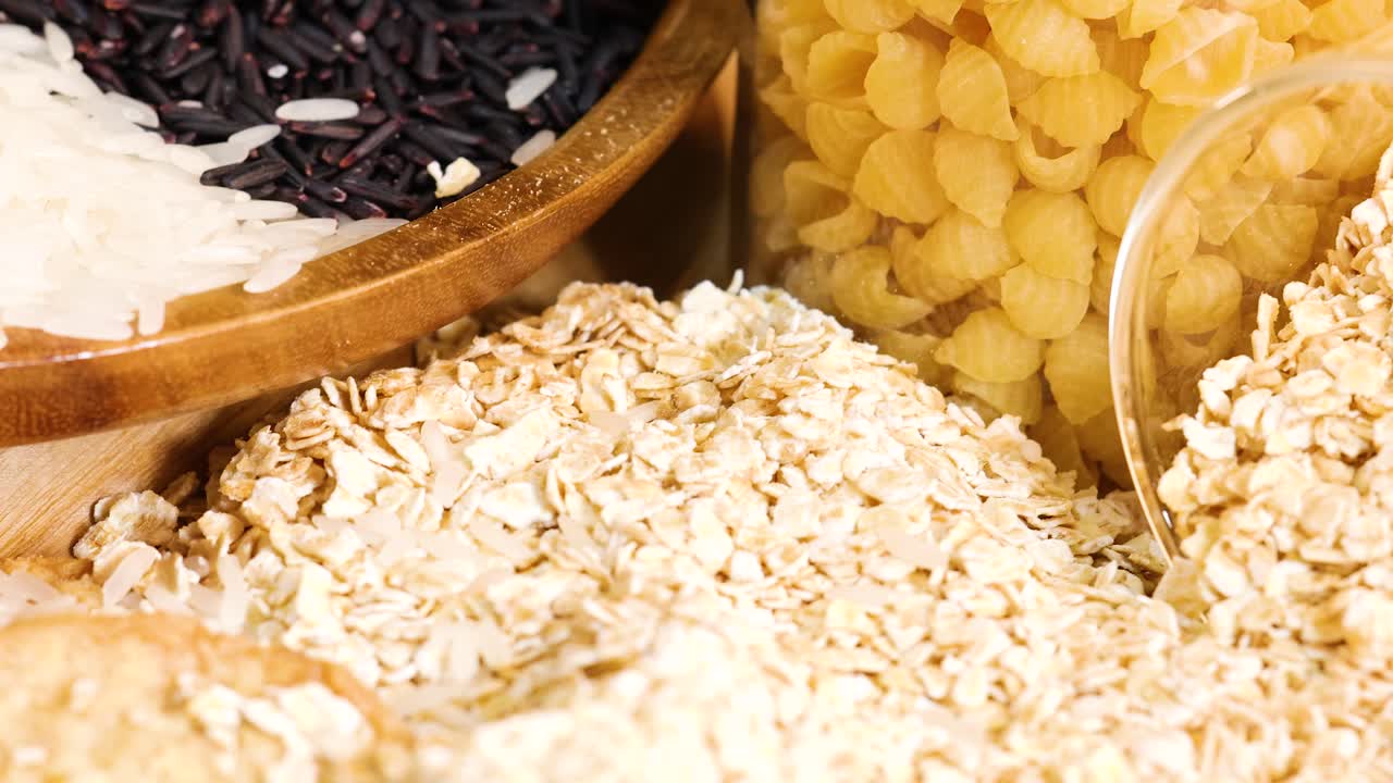 Close-up of various grains and sliced bread, highlighting textures and colors under warm lighting