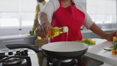 A-senior-African-american-couple-cooking-at-home.-Social-distancing-in-quarantine