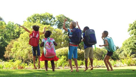 Group-of-kids-jumping-together-in-park