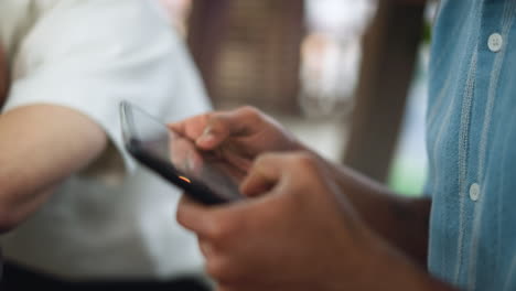 blurry close up of hand tapping phone tablet screen with gentle motion subtle focus shift capturing casual digital interaction ambient light glow highlighting fingertip gesture on glass surface text