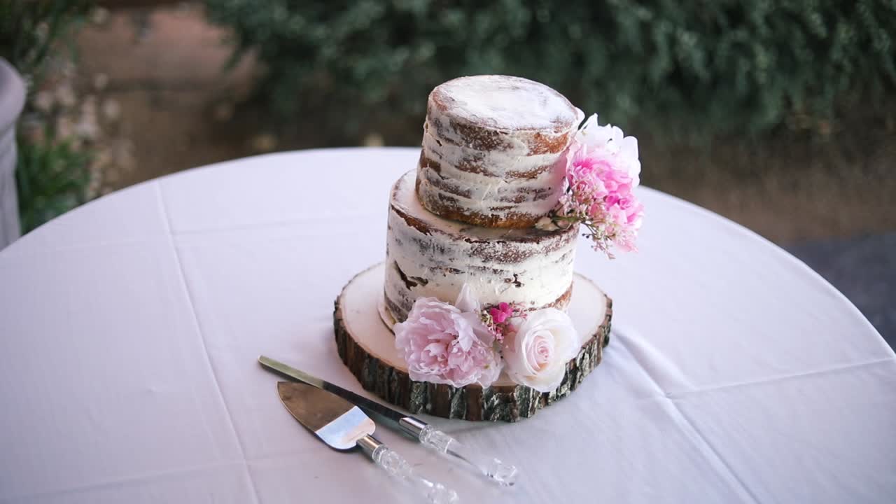 Plano suave de um lindo bolo de casamento intocado sobre uma mesa durante uma recepção de casamento