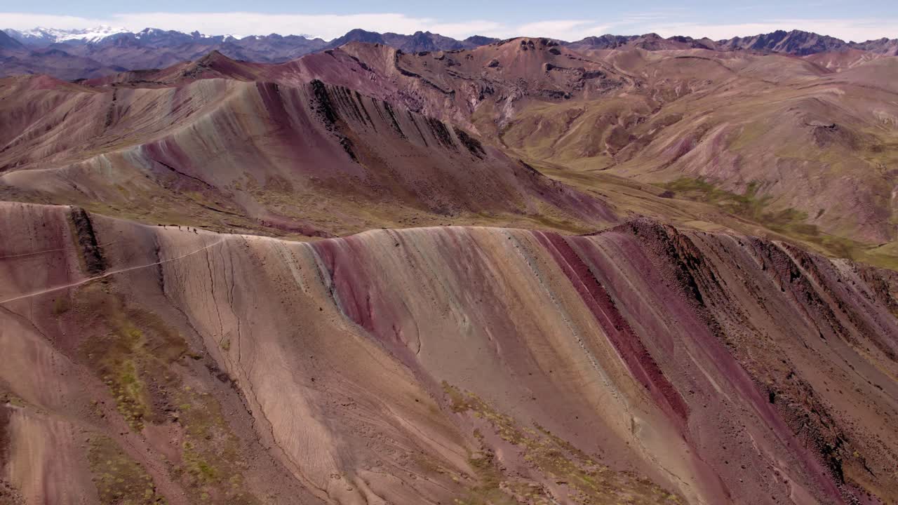 Majestic hills display a spectrum of colors, revealing fascinating geological layers. This landscape captures the beauty of nature in the Andes during daylight.