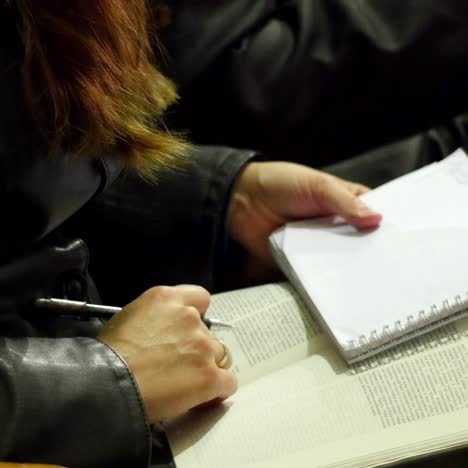 college student taking notes while studying