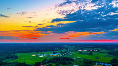 vivid hdr golden hour sunset to blue hour dusk over water and fields under colorful clouds