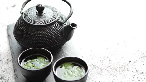 traditional eastern metal teapot and iron cups