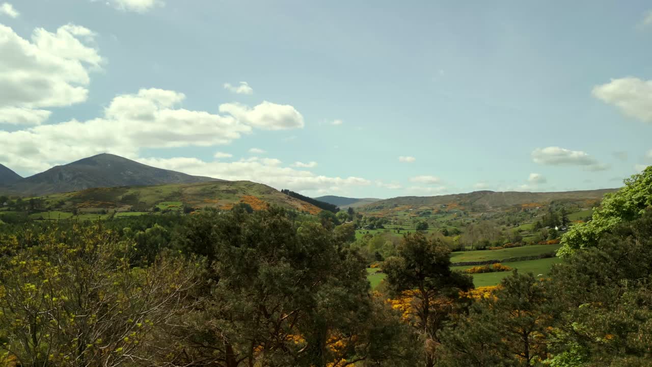 Aerial video of the Mourne Mountains and Slieve Donard in Newcastle, County Down in Northern Ireland, UK on a bright and sunny day. Filmed in 4K, 60fps and with Rec709 Color.