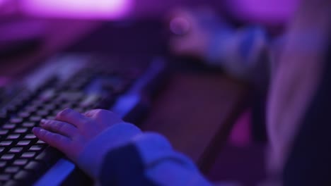 close up hands shot showing a gamer pushing the keyboard buttons while playing an online video game-1