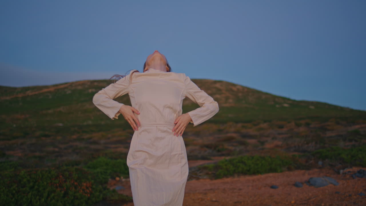 Active dancer performing nature green hills at summer evening. Woman dancing