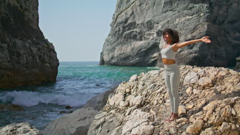 woman stretching beach summer morning vertical. girl practicing yoga near ocean.